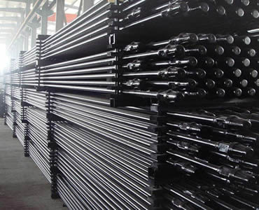 Several pallets of hollow sucker rod are placed in the warehouse.