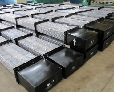 Several pallets sucker rod on the ground with plastic paper covering the rod body and metal box covering the rod head.